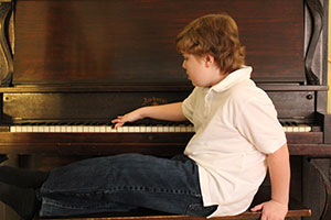 At the Piano - child sitting at the piano